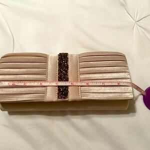 Gold satin clutch purse with shiny embellishments.